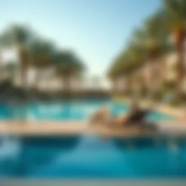 Serene pool area surrounded by palm trees at The Edge by Rotana